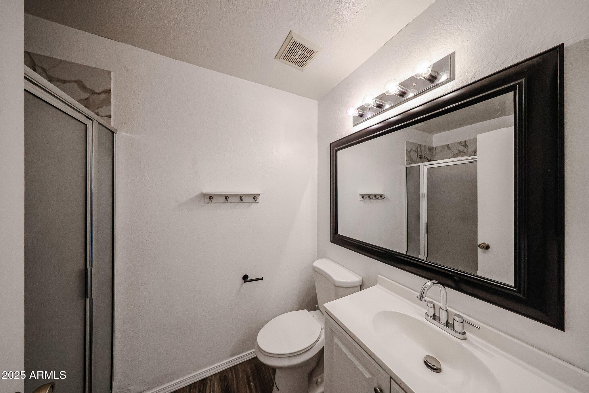 7977 West Wacker Road, Unit 245 Peoria, AZ 85381 - Photo 17 of 42 a bathroom with a sink a toilet and a mirror