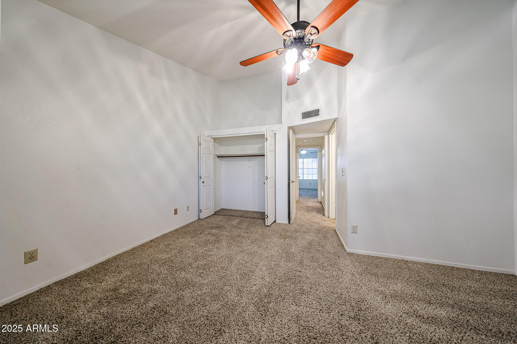 7977 West Wacker Road, Unit 245 Peoria, AZ 85381 - Photo 39 of 42 an empty room with a fan and a fan