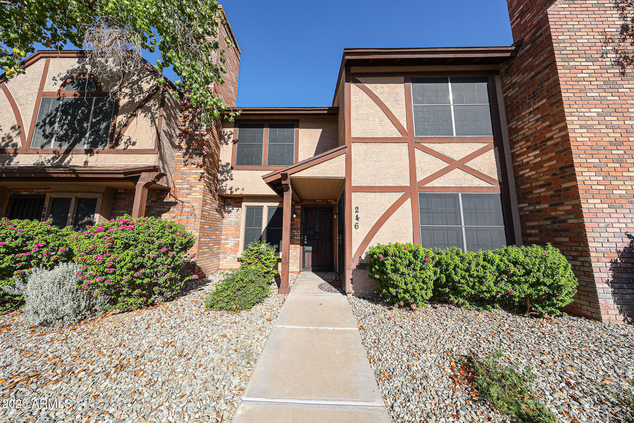 7977 West Wacker Road, Unit 245 Peoria, AZ 85381 - Photo 6 of 42 a front view of a house with garden