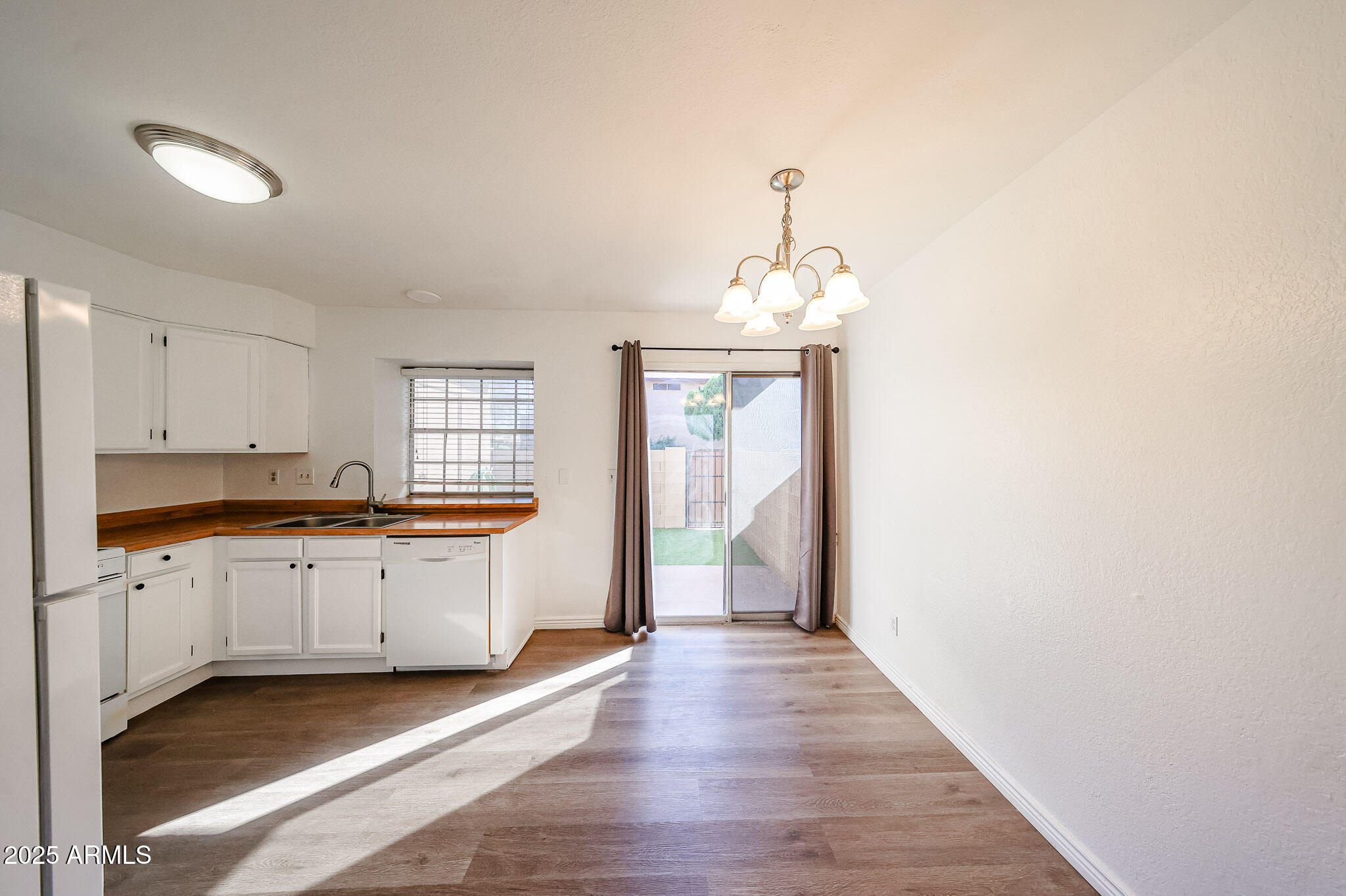 7977 West Wacker Road, Unit 245 Peoria, AZ 85381 - Photo 8 of 42 a kitchen with granite countertop a sink cabinets and wooden floor