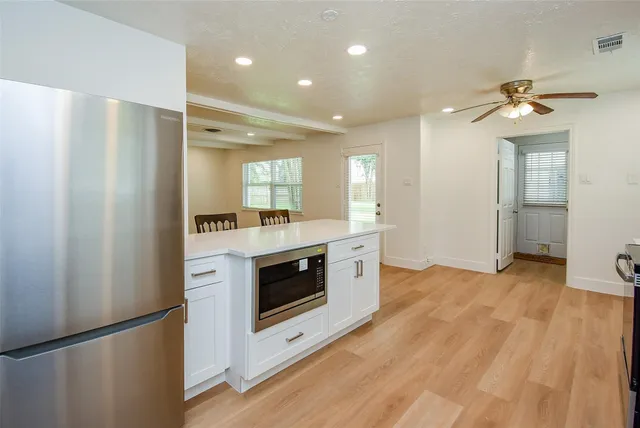 a kitchen with stainless steel appliances a stove top oven and a refrigerator