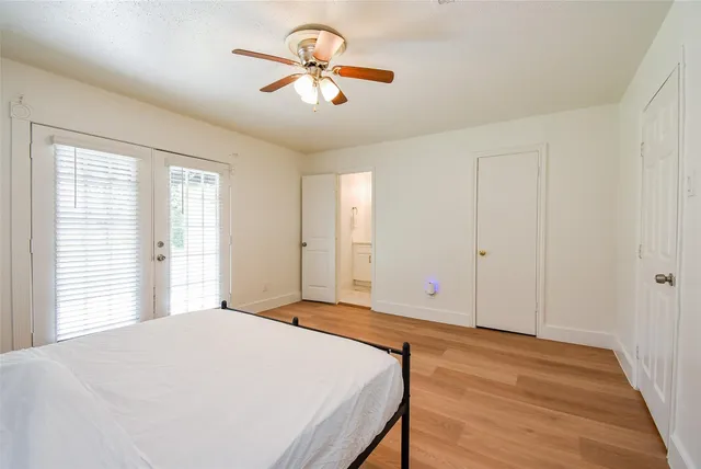 a bedroom with a large bed and a chandelier