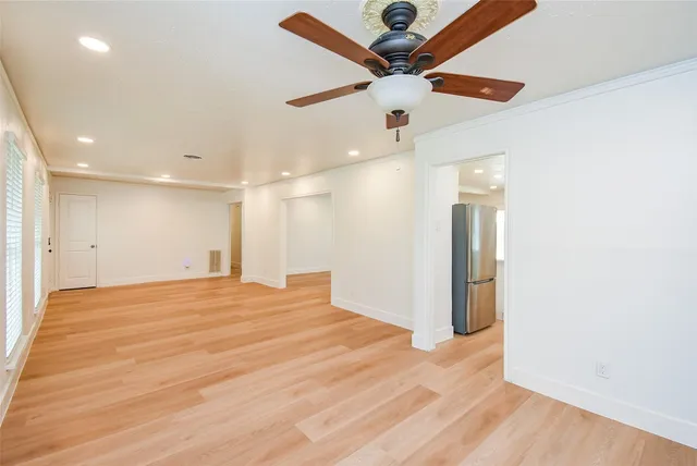 a view of an empty room with a ceiling fan