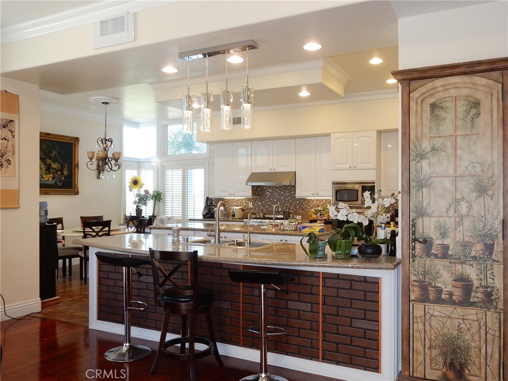 20128 Candleflame Court Walnut, CA 91789 - Photo 11 of 46 a kitchen with a table chairs stove and cabinets