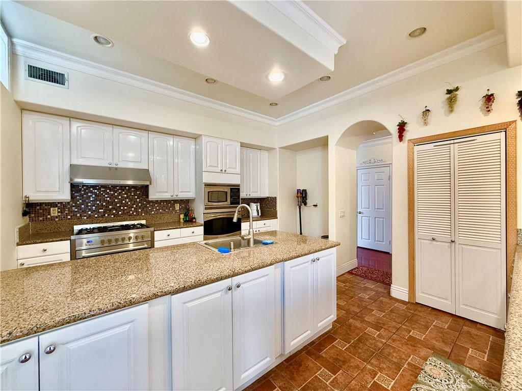 20128 Candleflame Court Walnut, CA 91789 - Photo 12 of 46 a kitchen with stainless steel appliances granite countertop a sink stove and cabinets