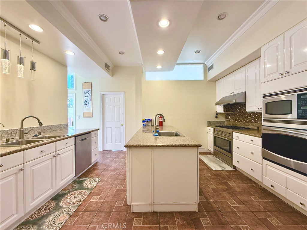 20128 Candleflame Court Walnut, CA 91789 - Photo 13 of 46 a kitchen with granite countertop a sink and cabinets
