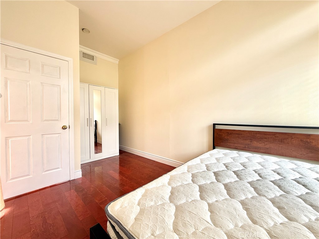 20128 Candleflame Court Walnut, CA 91789 - Photo 24 of 46 a bedroom with a bed and wooden floor