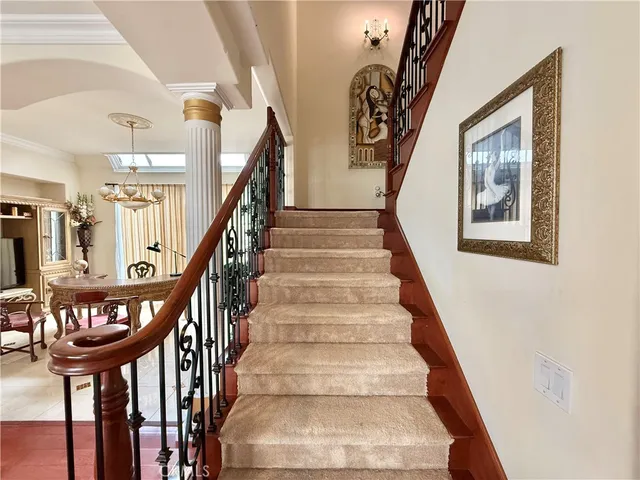 a view of staircase with lots of frames and frames on wall