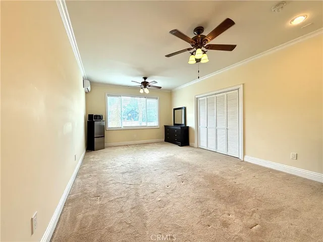 a view of a livingroom with a ceiling fan and window