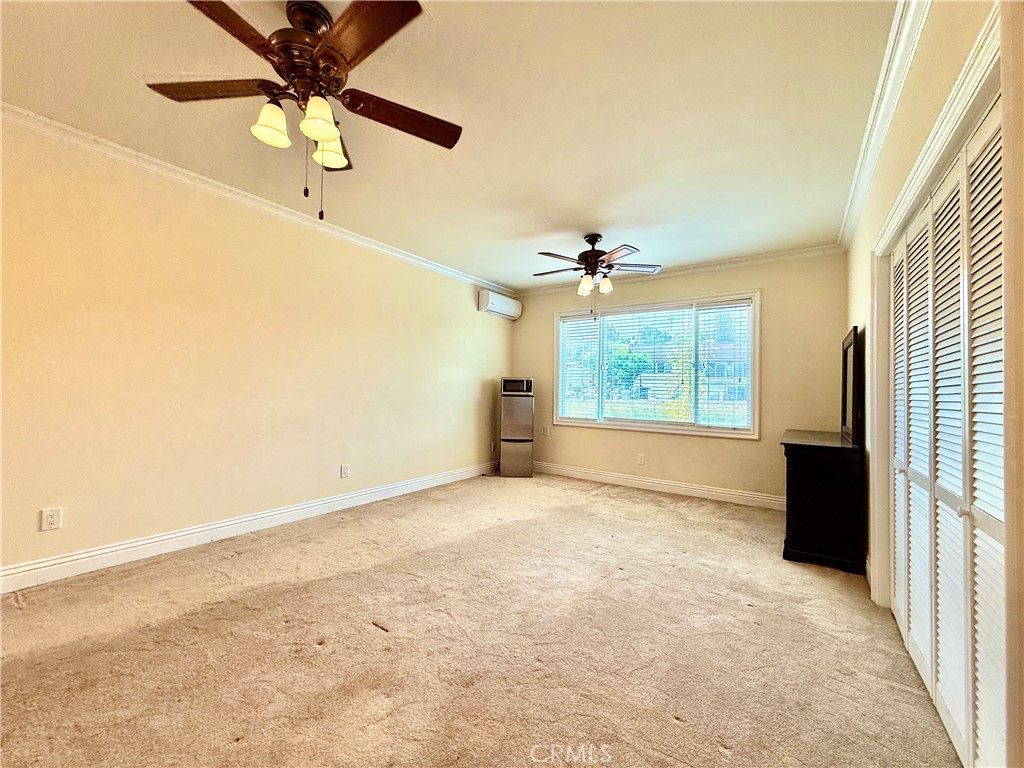 20128 Candleflame Court Walnut, CA 91789 - Photo 35 of 46 en empty room with windows and chandelier fan