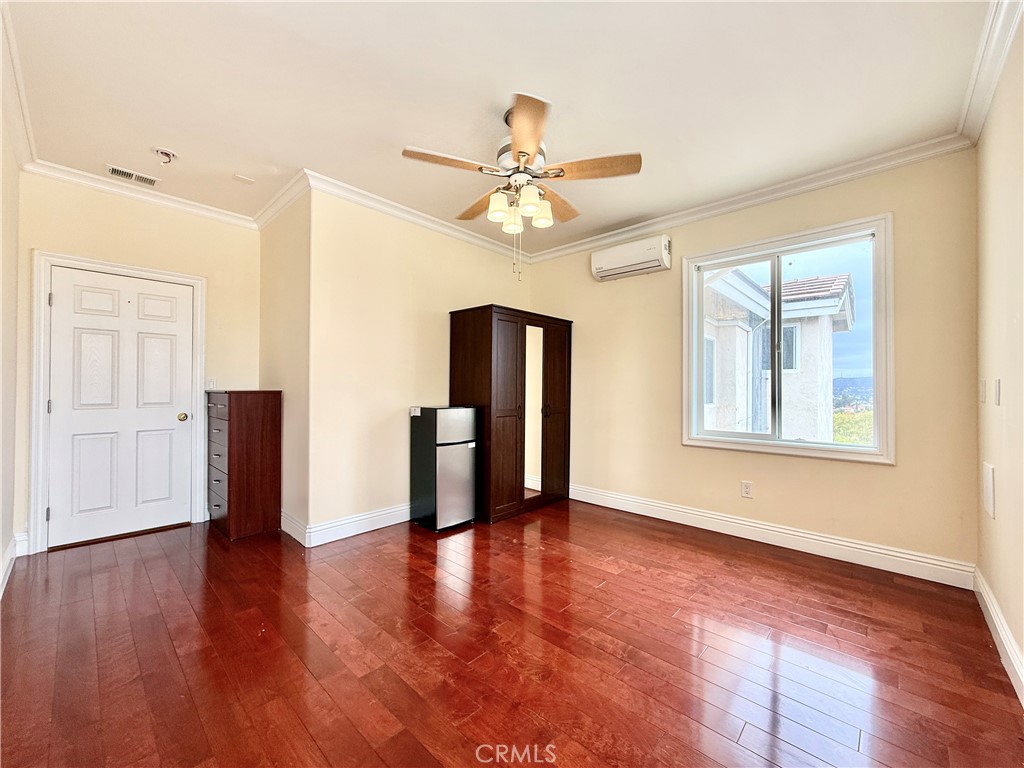 20128 Candleflame Court Walnut, CA 91789 - Photo 39 of 46 a view of an empty room with window and wooden floor