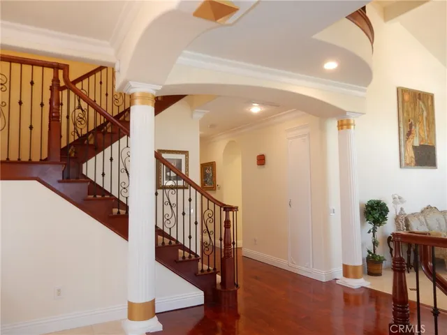 a view of entryway and hall with wooden floor