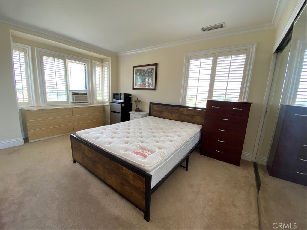 20128 Candleflame Court Walnut, CA 91789 - Photo 9 of 46 a bed sitting in a bedroom next to a window