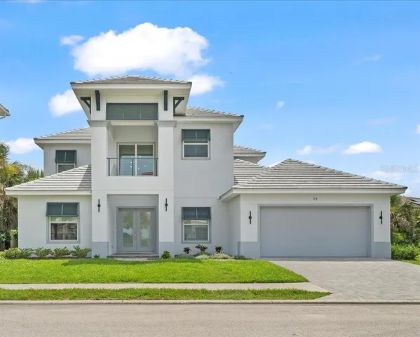 a front view of a house with a garden and garage