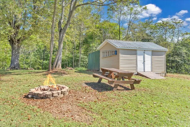 a backyard of a house with table and chairs