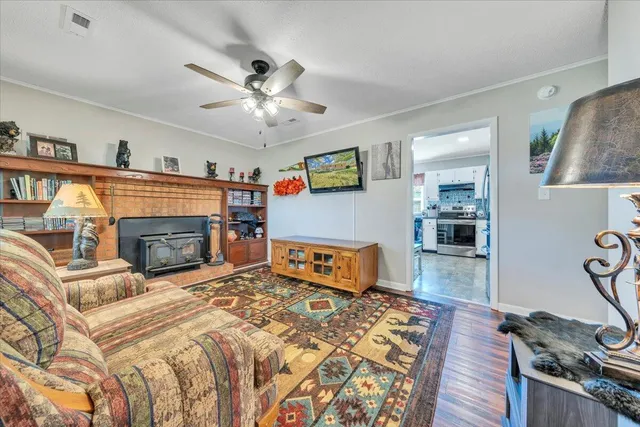 a bedroom with a bed a fireplace and a flat tv screen