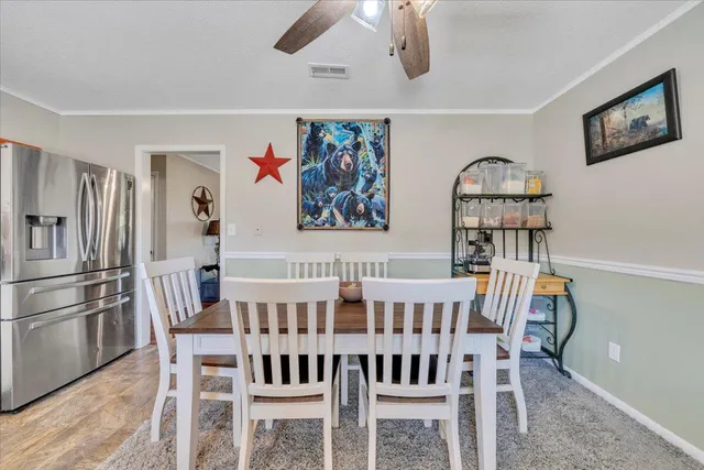 a view of a dining room with furniture wooden floor and chandelier