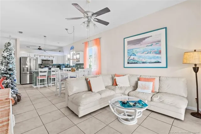 a living room with furniture and a view of kitchen