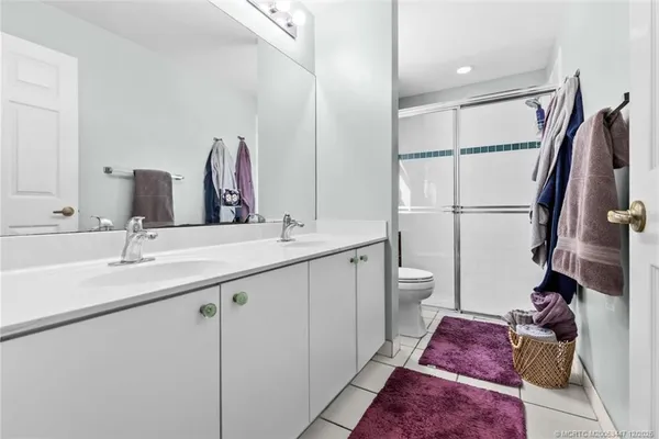 a bathroom with a double vanity sink and a mirror
