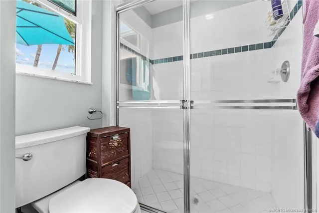 a white toilet sitting next to a bathroom sink