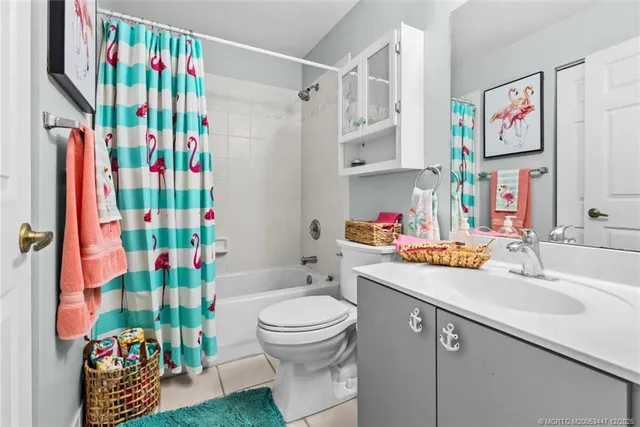 a bathroom with a sink toilet and shower curtain