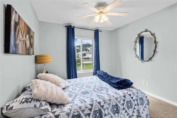a bedroom with a large bed and a chandelier