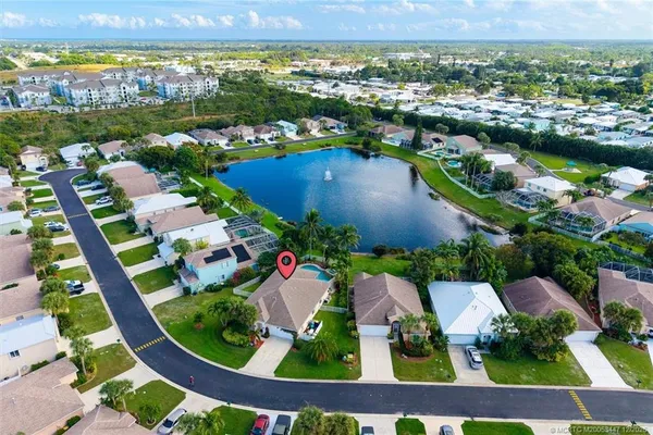 an aerial view of residential houses with outdoor space and swimming pool