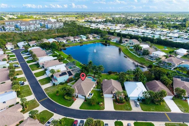 an aerial view of residential houses with outdoor space and swimming pool