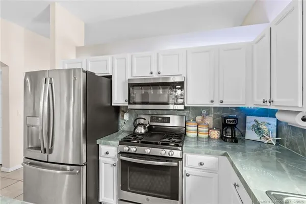 a kitchen with a stove and a refrigerator
