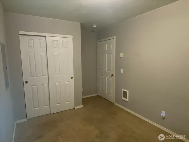 an empty room with closet area