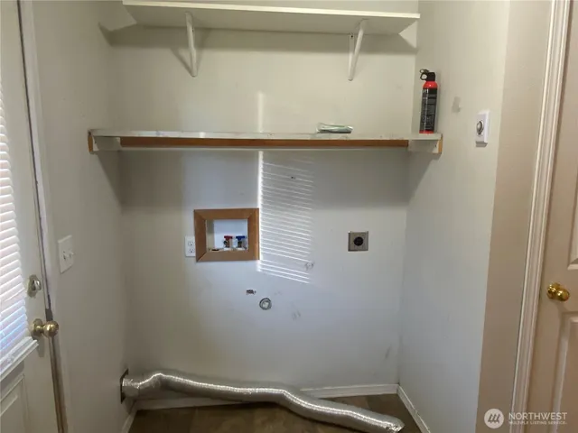 a view of a room with wooden floor and cabinet