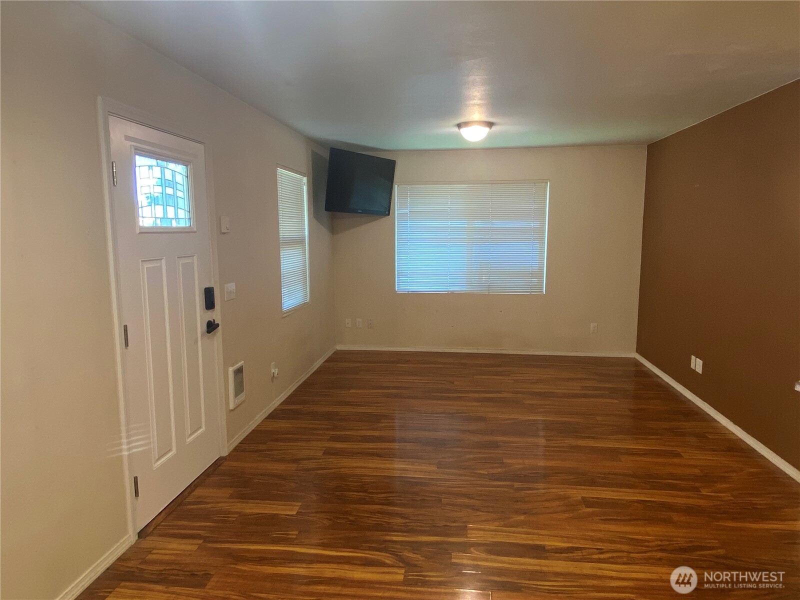 320 C Street South Bend, WA 98586 - Photo 3 of 25 a view of an empty room with wooden floor and a window