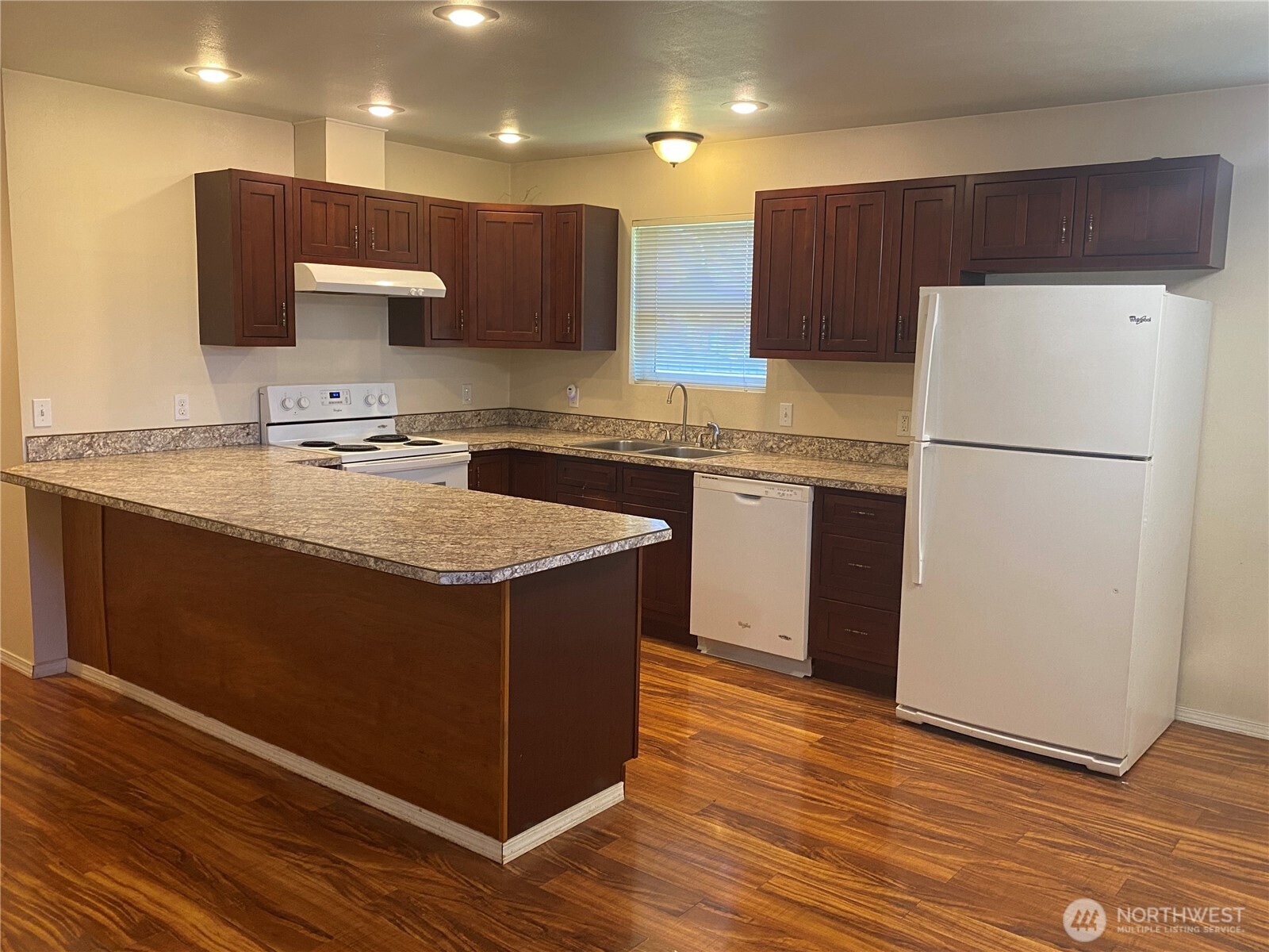 320 C Street South Bend, WA 98586 - Photo 6 of 25 a kitchen with kitchen island granite countertop wooden cabinets a refrigerator a sink and a stove