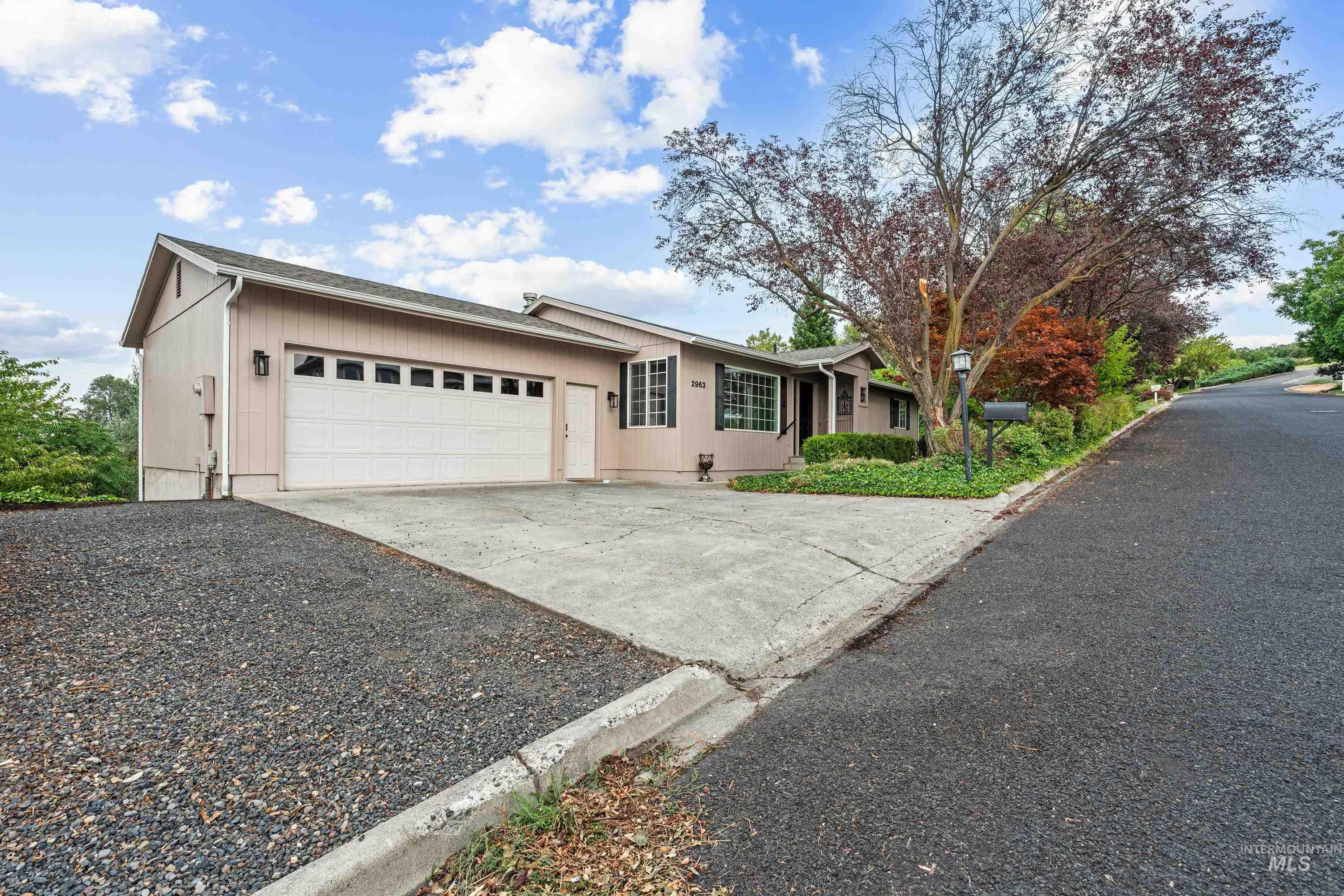 2963 Mayfair Ridge Lewiston, ID 83501 - Photo 1 of 45 Single-story residence featuring a two-car garage with panel doors, multi-pane windows, and established landscaping