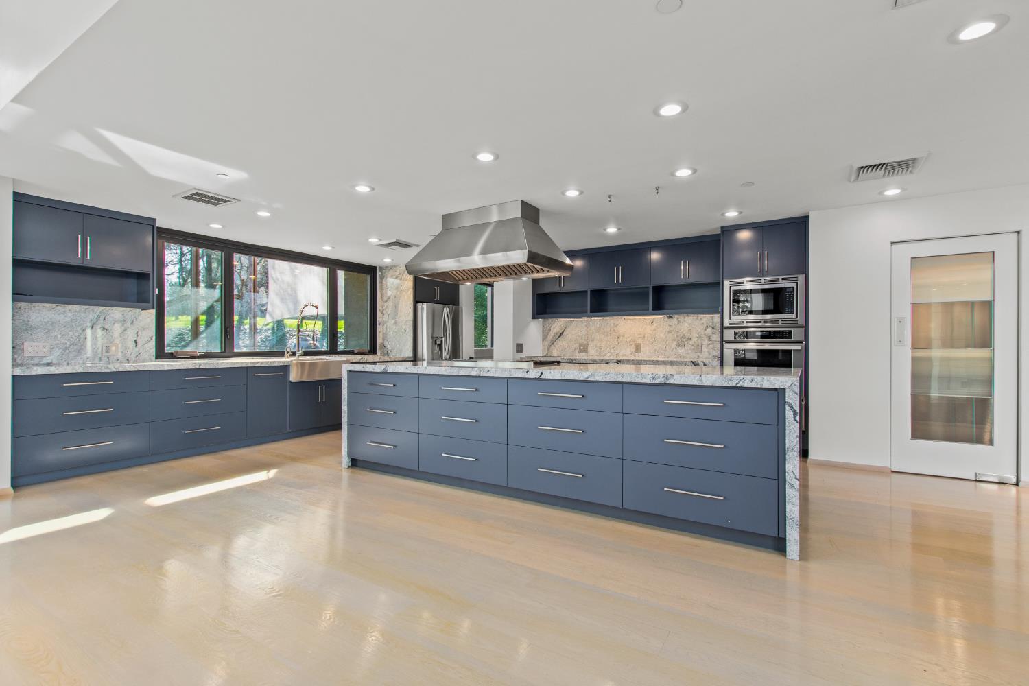12100 Horseshoe Road Oakdale, CA 95361 - Photo 17 of 77 a large kitchen with stainless steel appliances kitchen island granite countertop a large counter top and a stove top oven