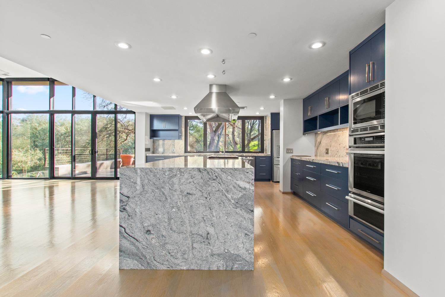 12100 Horseshoe Road Oakdale, CA 95361 - Photo 23 of 77 a open kitchen with stainless steel appliances kitchen island granite countertop a refrigerator a stove and a sink with large countertops