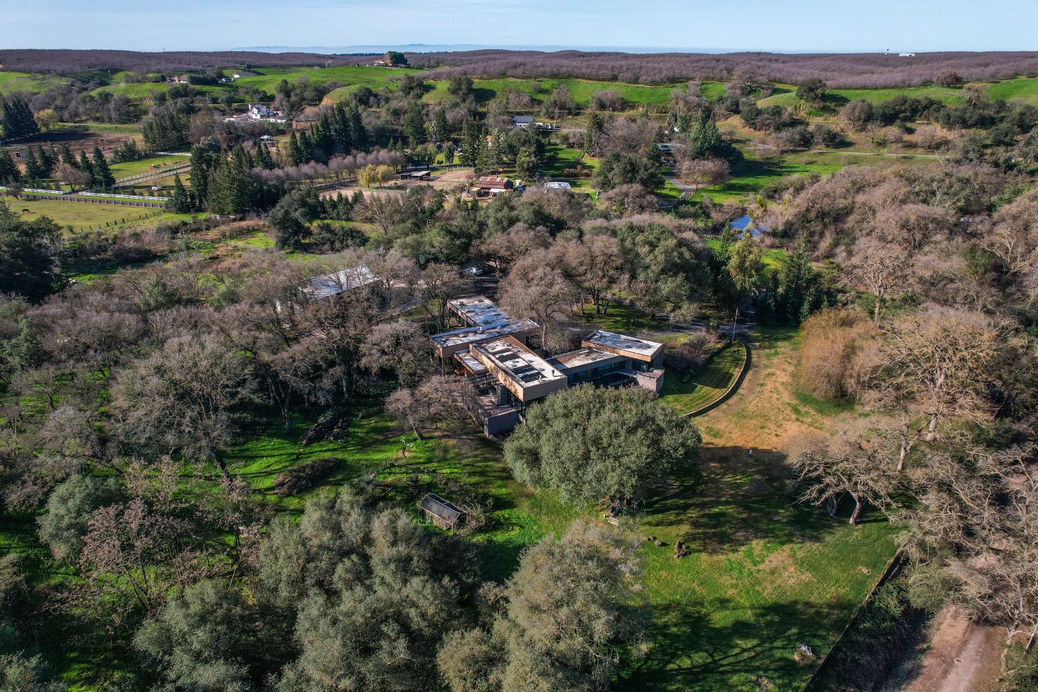 12100 Horseshoe Road Oakdale, CA 95361 - Photo 3 of 77 an aerial view of residential house with outdoor space and trees all around