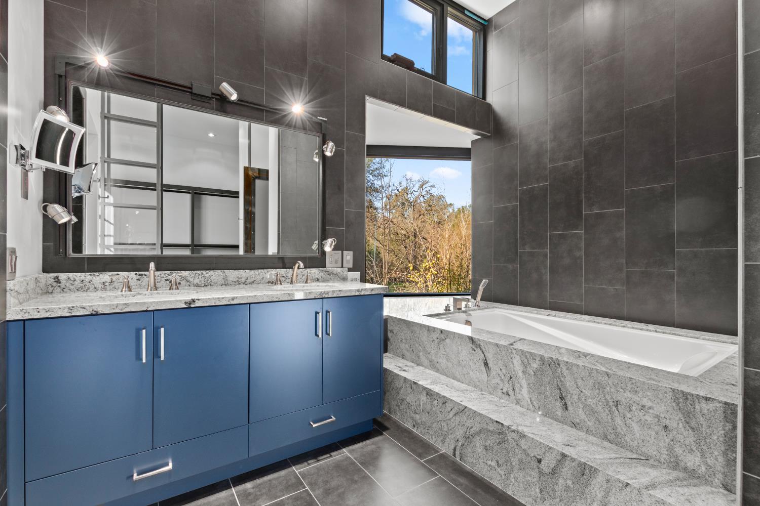 12100 Horseshoe Road Oakdale, CA 95361 - Photo 41 of 77 a bathroom with a granite countertop sink mirror and bathtub