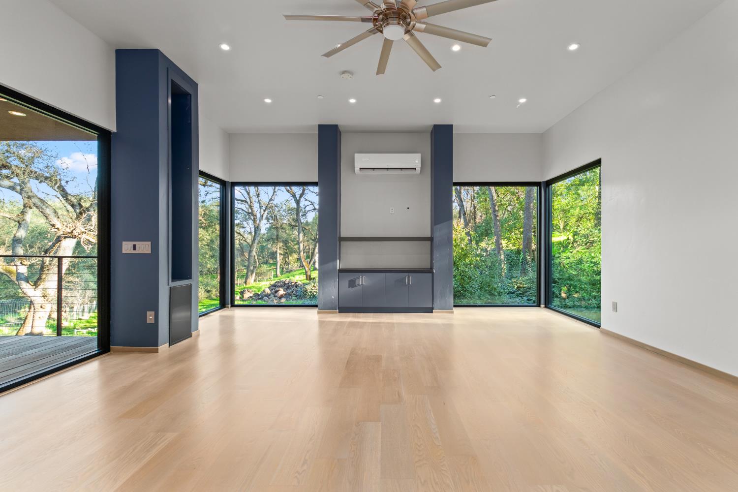 12100 Horseshoe Road Oakdale, CA 95361 - Photo 56 of 77 a view of an empty room with a fireplace and a window
