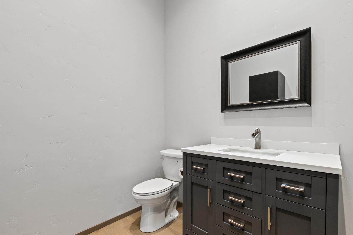 12100 Horseshoe Road Oakdale, CA 95361 - Photo 60 of 77 a bathroom with a toilet sink and mirror