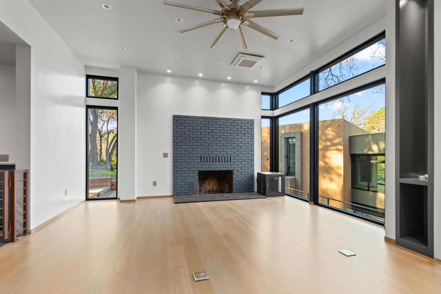 12100 Horseshoe Road Oakdale, CA 95361 - Photo 61 of 77 a view of an empty room with a fireplace and a window