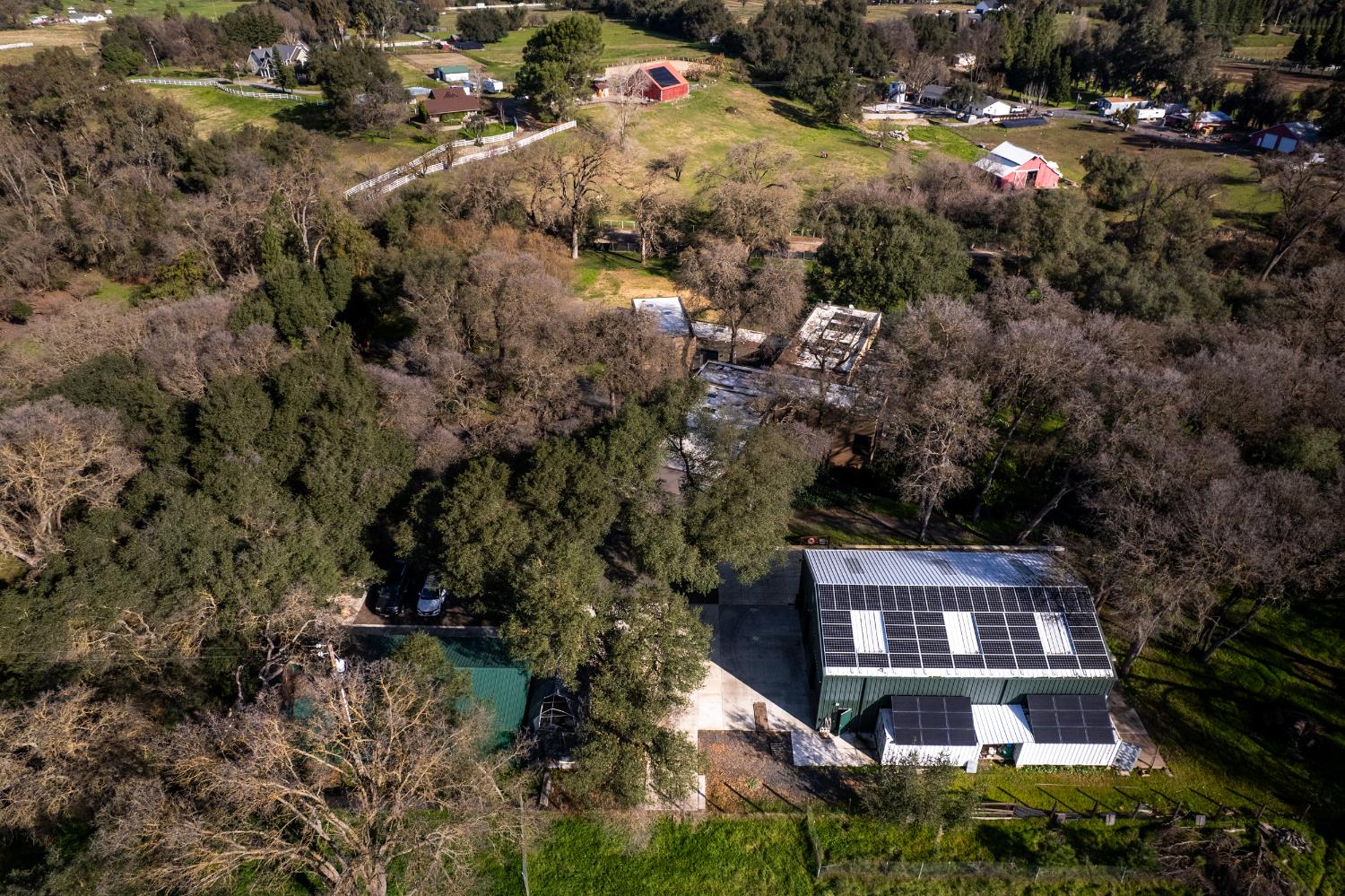 12100 Horseshoe Road Oakdale, CA 95361 - Photo 77 of 77 an aerial view of a house with a yard and large trees