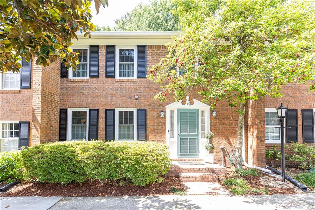 4620 Wieuca Road Northeast, Unit 25 Atlanta, GA 30342 - Photo 1 of 1 front view of a house with a yard