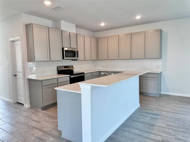 a kitchen with cabinets a sink and a counter top space