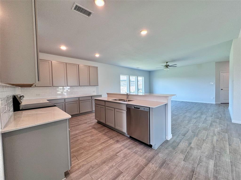 1919 Aleia Cove Sherman, TX 75092 - Photo 14 of 32 a large kitchen with a lot of counter space and wooden floor