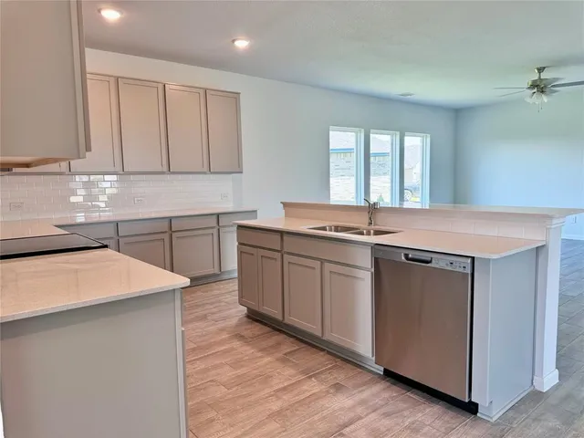 a kitchen with stainless steel appliances granite countertop a sink stove and cabinets