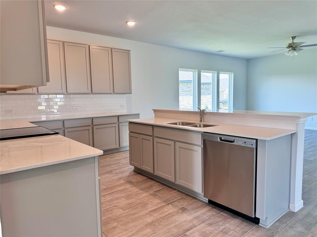 1919 Aleia Cove Sherman, TX 75092 - Photo 15 of 32 a kitchen with stainless steel appliances granite countertop a sink stove and cabinets