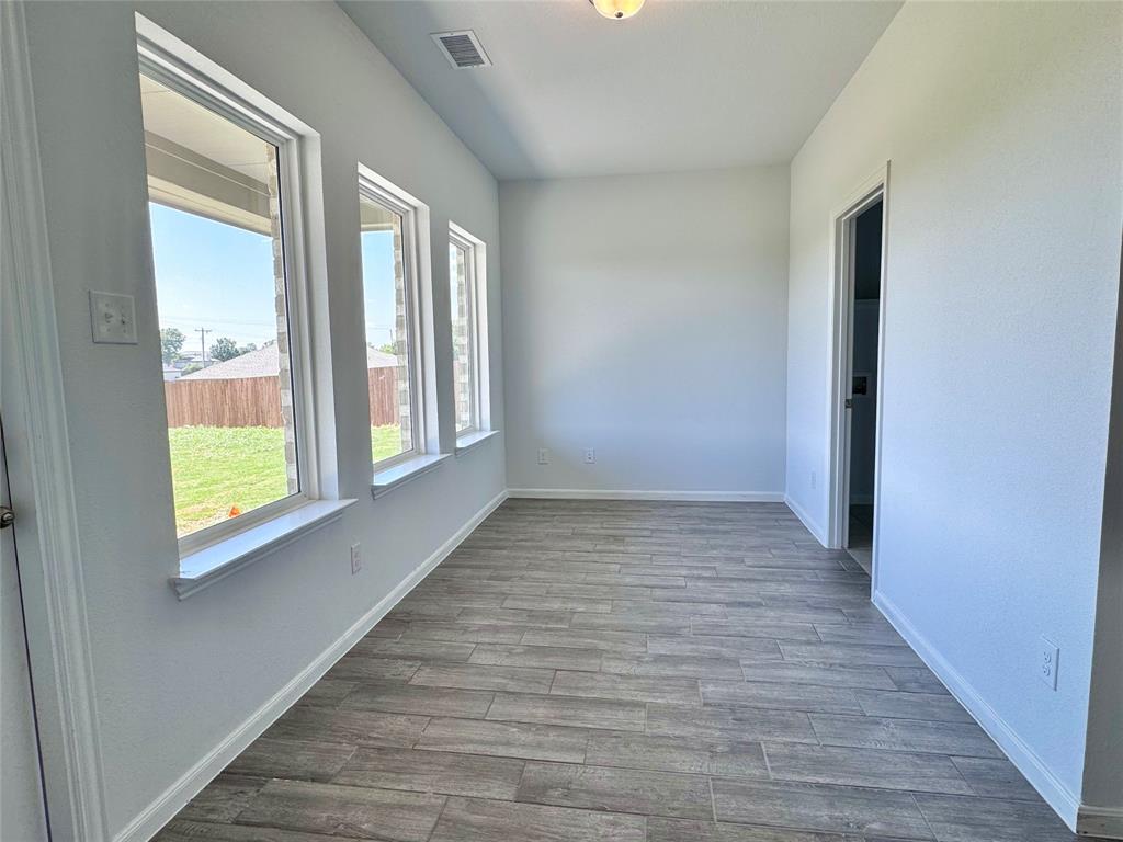 1919 Aleia Cove Sherman, TX 75092 - Photo 17 of 32 a view of an empty room with wooden floor and a window