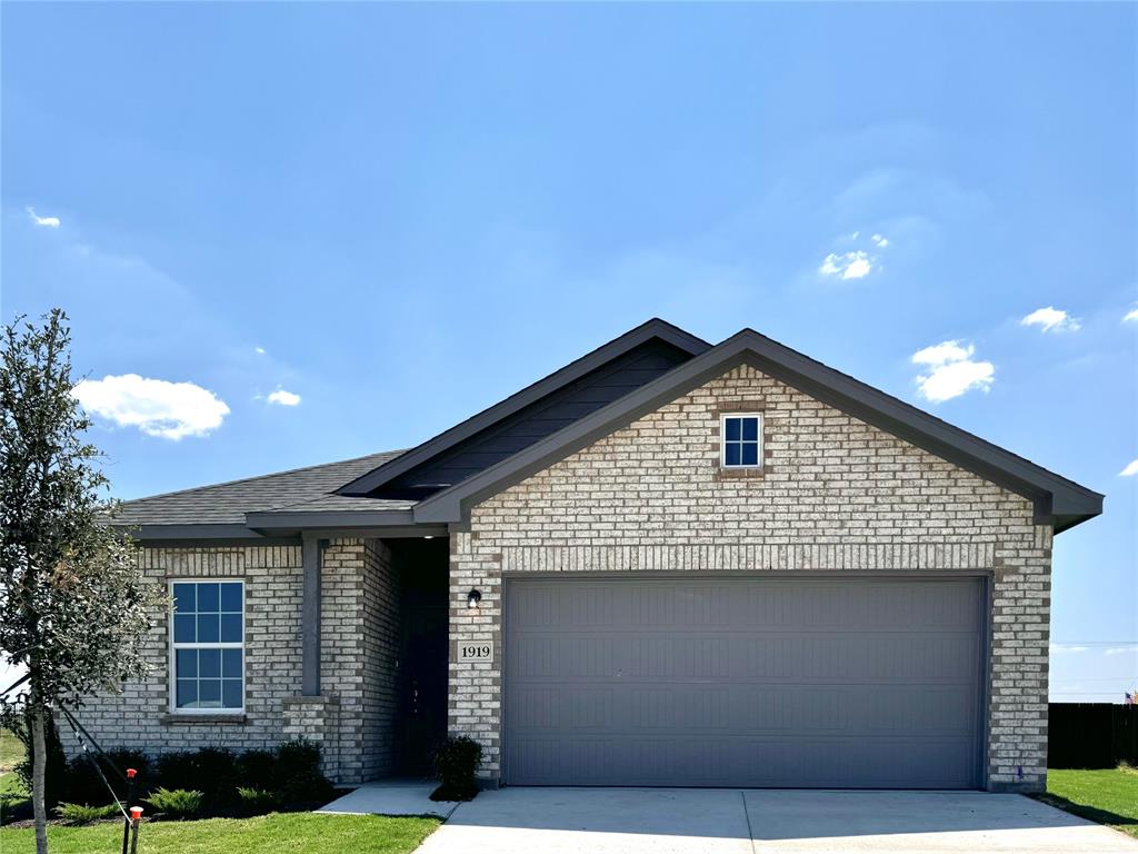 1919 Aleia Cove Sherman, TX 75092 - Photo 2 of 32 a front view of a house with garden