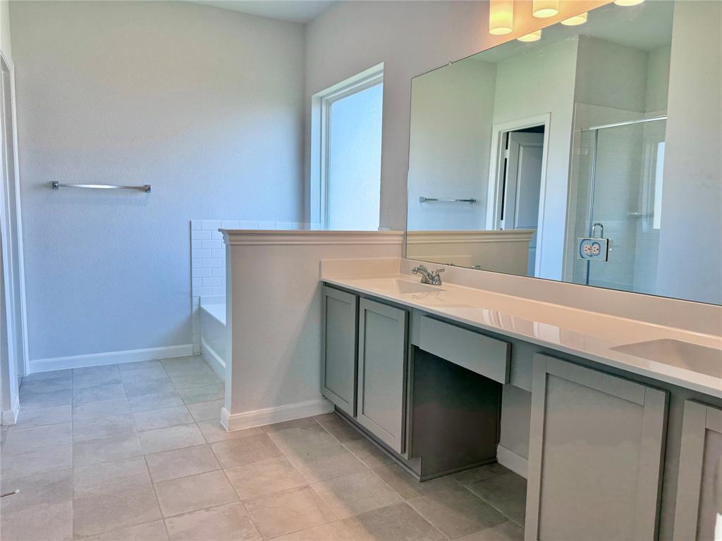 1919 Aleia Cove Sherman, TX 75092 - Photo 22 of 32 a bathroom with a sink and a mirror